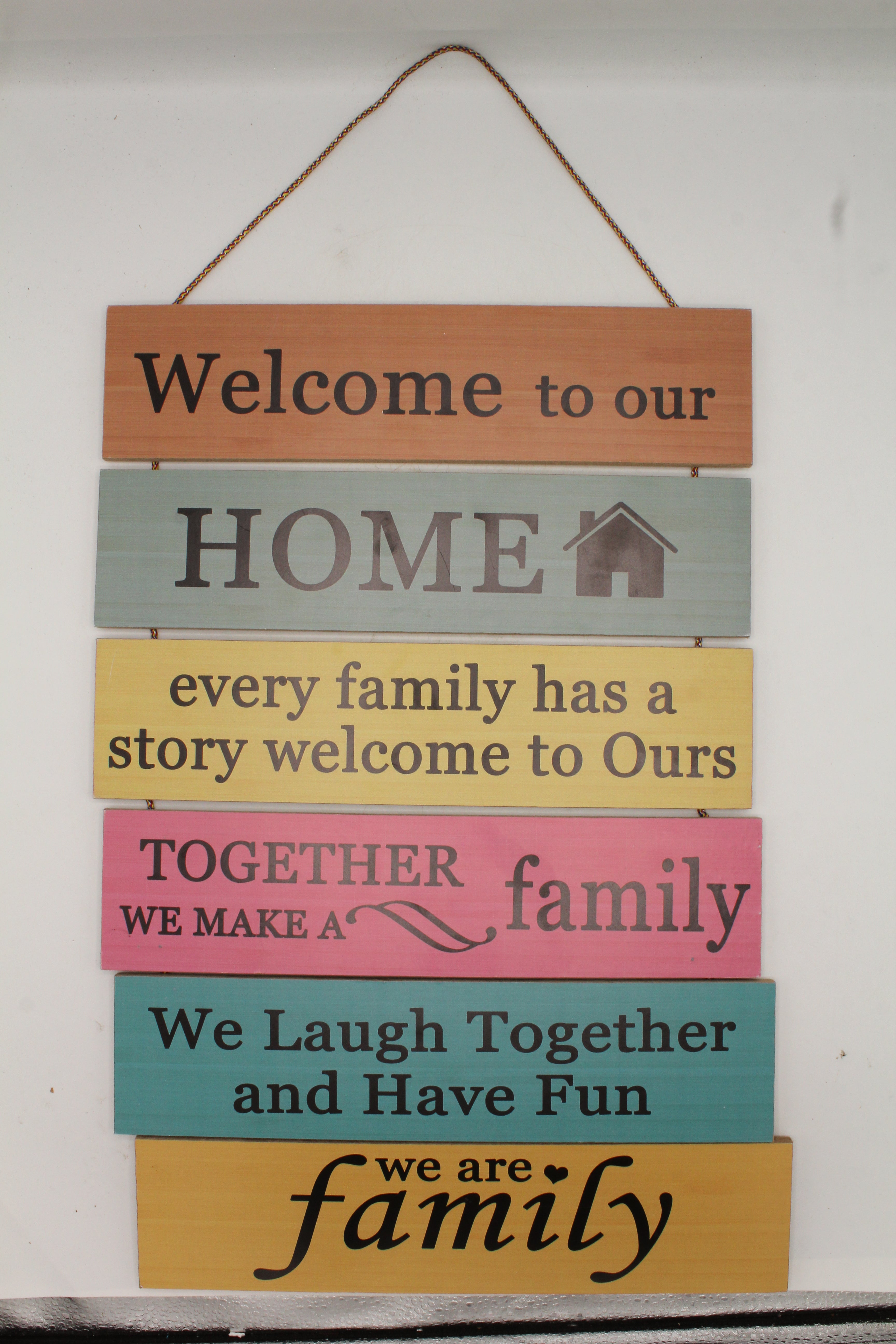 Welcome to Our Home Family Story Rules Multi-Color Hanging Slat Sign